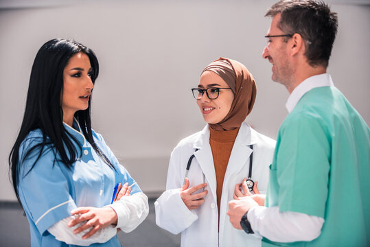 A diverse medical team collaborates discussing patient care in a hospital. The healthcare professionals dressed in uniforms share their expertise and insights to provide the best possible treatment. - Powered by Adobe