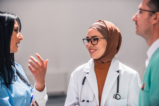 A diverse medical team collaborates discussing patient care in a hospital. The healthcare professionals dressed in uniforms share their expertise and insights to provide the best possible treatment. - Powered by Adobe