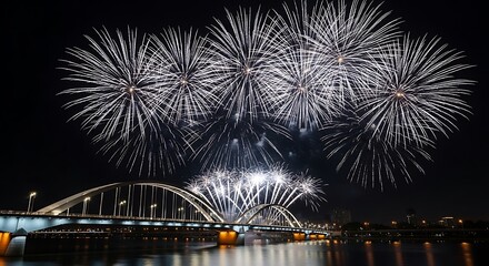 Spectacular white fireworks illuminate modern bridge at night