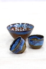 Beautiful blue Japanese ceramics on a light fabric background.