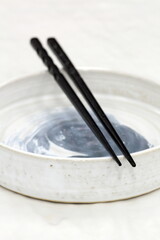 Colorful chopsticks in their tabletop holders, viewed from above.