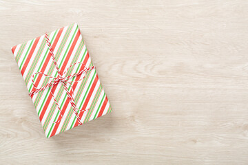 Obraz premium Striped Christmas gift boxes on wooden background, top view