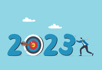 Year 2023 business target, new year resolution or challenge to achieve goal, aim for business success, growth or motivation to succeed concept, businessman changing year to 2023 target