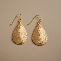 Elegant gold earrings featuring a textured teardrop design. This close-up captures the beauty and intricate details of the jewelry.