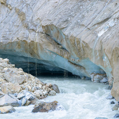 Detailed close-up of glacier ice, highlighting texture, cracks, and blue tones in a natural cold environment.
