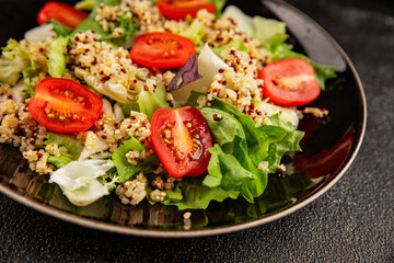 Quinoa salad tomato, green leaf salad vegetables dish natural product tasty snack fresh gourmet food background on the table rustic top view copy space keto and paleo diet vegan and vegan food