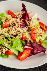Quinoa salad tomato, green leaf salad vegetables dish natural product tasty snack fresh gourmet food background on the table rustic top view copy space keto and paleo diet vegan and vegan food