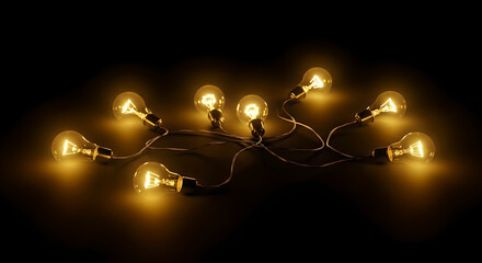 String of vintage edison light bulbs glowing warmly in the dark