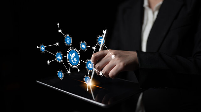A business professional engages with a tablet, showcasing advanced digital networking through bright icons symbolizing communication and technological innovation. Tessel