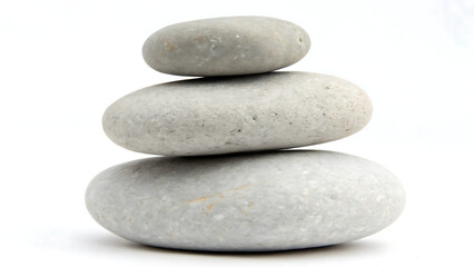 Fototapeta premium Three smooth grey stones stacked in perfect balance on a white background