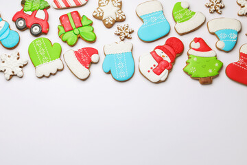 Tasty gingerbread cookies on white background, flat lay with space for text. Christmas treat