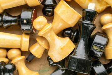 Vintage wooden chess pieces on a chessboard, close-up, top view.