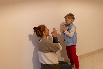Mother and child playing hand clapping game together