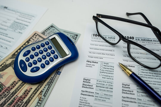 Financial review with 1040 form, US dollar notes, glasses and calculator — 2025 report