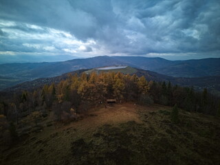 Aerial view of mountain shelter and pumped-storage reservoir in cloudy autumn weather