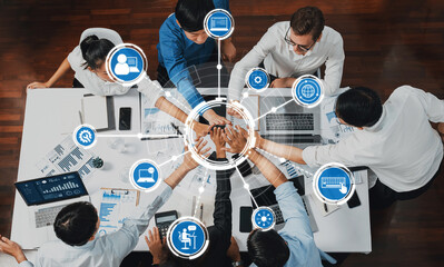 Top view diverse office worker join hand together in office room symbolize business synergy and strong productive teamwork in workplace. Cooperation and unity between business employee. Prudent Amity