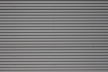 Obraz premium Corrugated galvanized steel panels on the exterior of a building. For background, wallpaper or clipping mask.