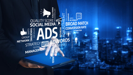 A business professional displays digital marketing concepts on a tablet, highlighting various advertising terms in a modern cityscape, symbolizing innovation in strategy. Tessel