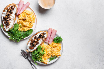 Healthy balanced breakfast with scrambled eggs, sandwich, ham
