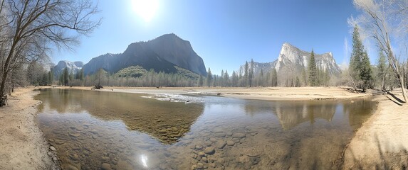Panoramic view of Yosemite Valley with Merced River and granite cliffs under clear blue sky mountains