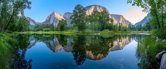 Panoramic view of Yosemite Valley with calm water reflecting mountains and trees California nature