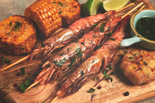langoustines on skewers, shrimp kebab, with fried corn, spices and herbs, homemade, no people,