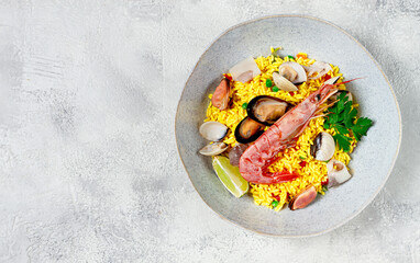 seafood paella, on a plate, traditional Spanish dish, top view, no people,
