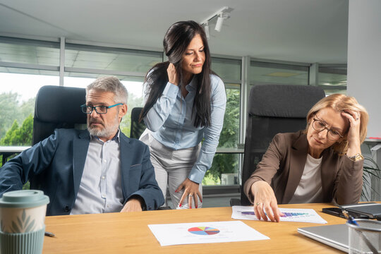 Business team in tense meeting showing disagreement and conflict over ideas