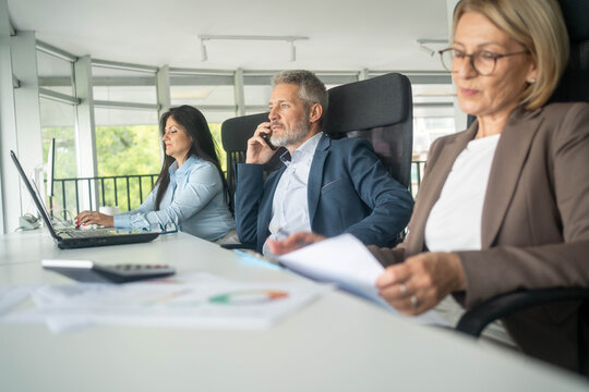 Planning, teamwork and meeting with business people in boardroom for strategy, brainstorming and solution. Corporate, collaboration and conference with employees in office for negotiation development - Powered by Adobe