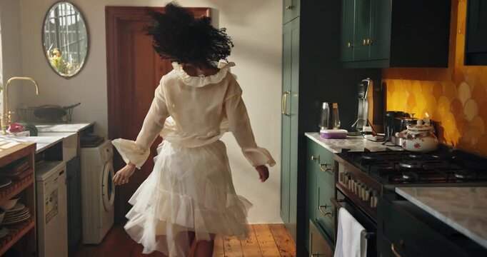 Happy, dancing and woman in kitchen in home with music for rhythm on weekend break with entertainment. Energy, goofy and female person with listening to playlist for groove with fun in apartment.
