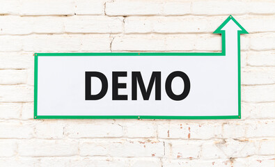 Obraz premium Demo symbol. Concept word Demo on beautiful white sign on old white brick wall. Beautiful brick old white wall background. Business and demo concept. Copy space.