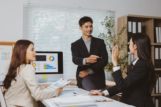 Group of diverse business professionals analyzing financial data and collaborating on new project ideas in a modern office