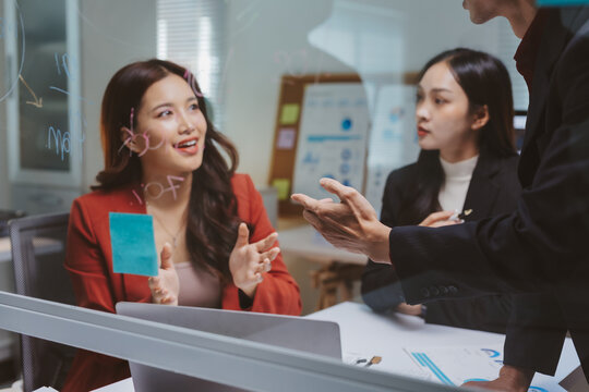 Business people collaborating and discussing new strategies during a creative planning session in a modern office environment