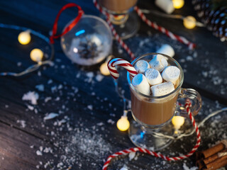 Hot cocoa with marshmallows on a table with Christmas decorations