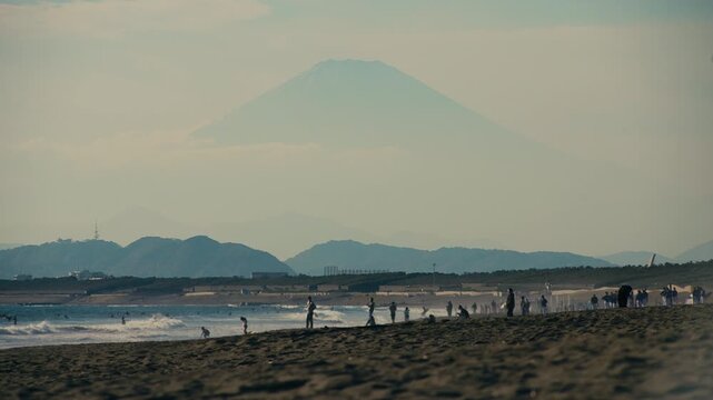 Telephoto view of Mount Fuji with golden sky from Chigasaki coast, Japan