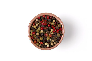 Mixed multicolored peppercorns in a ceramic bowl isolated on white background