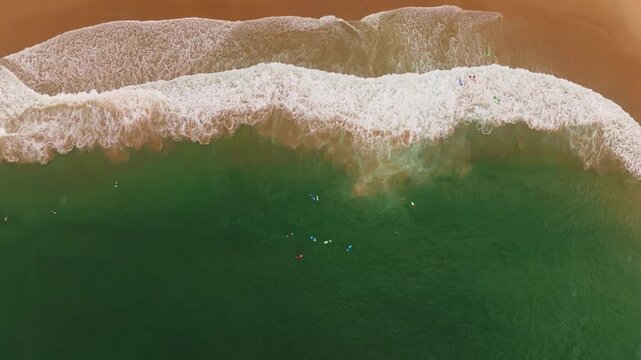 Surfers Riding Waves from Above at Costa da Caparica