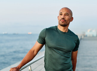 Portrait os a happy bhandsome black man exercising and stretching outdoors