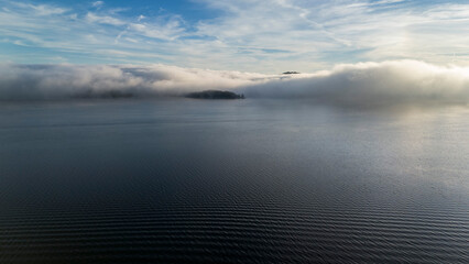 Fog over the lake on early fall day