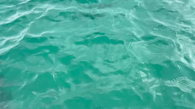 Crystal clear turquoise ocean water surface waves