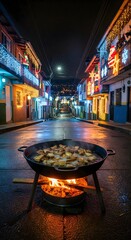 Traditional Colombian Fritanga Cooking on a Street Fire with Festive Christmas Lights Decoration in the Background at Night
