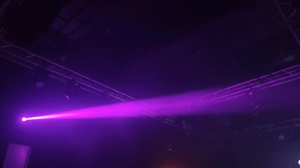 Stage Lights Showcasing Purple Beams in a Dark Venue for Concerts and Events