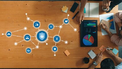 A top-down view of a collaborative workspace showcasing security data visualizations and infographics, illustrating the importance of cybersecurity analysis and team discussions. Amity
