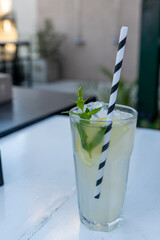 Mojito glass on table in rooftop bar