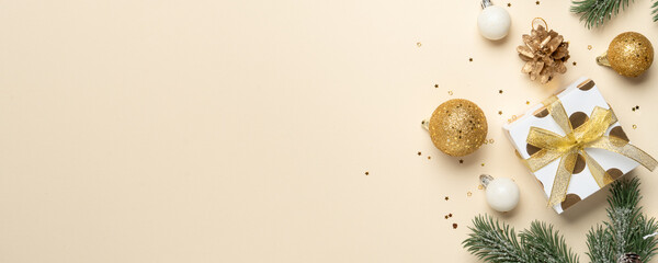 Christmas holidays decorations, gift box, balls and fir tree branches.