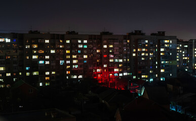 Apartment building with windows with lights on at night