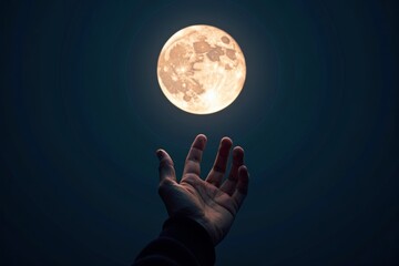 An Aerial View of a Hand Reaching Towards the Moon