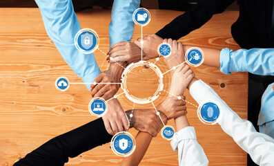 A diverse group of hands united on a table symbolizes collaborative security and innovation in the business environment, highlighting the importance of teamwork. Amity