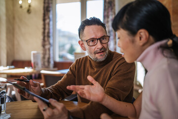 Business colleagues collaborating on tablet during an important meeting
