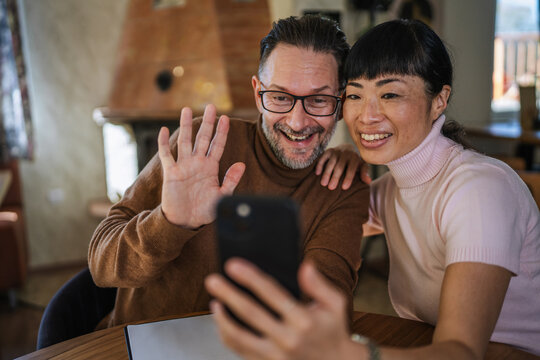 Multicultural couple having video call using smart phone